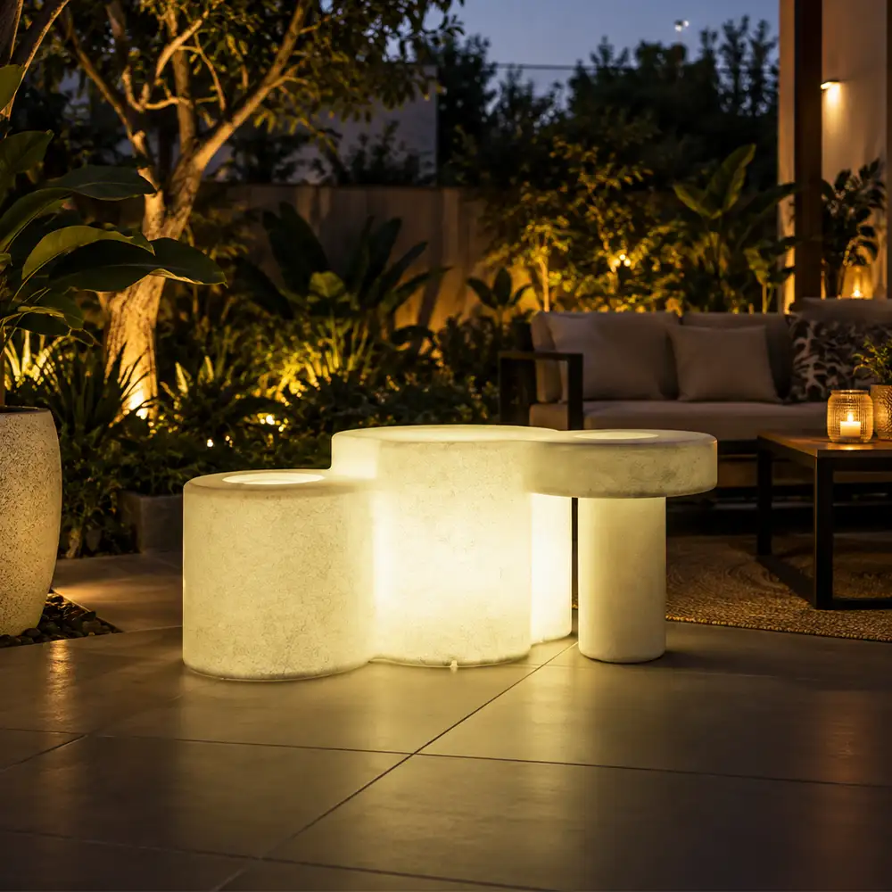 Celesta Illuminated Garden Bench — LED outdoor garden bench in White Stone glowing at dusk