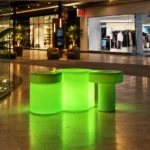 Celesta Illuminated Garden Bench — LED outdoor garden bench in White Stone glowing at dusk
