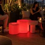 Celesta Illuminated Garden Bench — LED outdoor garden bench in White Stone glowing at dusk