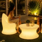 Marvella and Olivia Illuminated Set — LED outdoor chair and coffee table in White Stone glowing at night