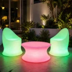 Marvella and Olivia Illuminated Set — LED outdoor chair and coffee table in White Stone glowing at night