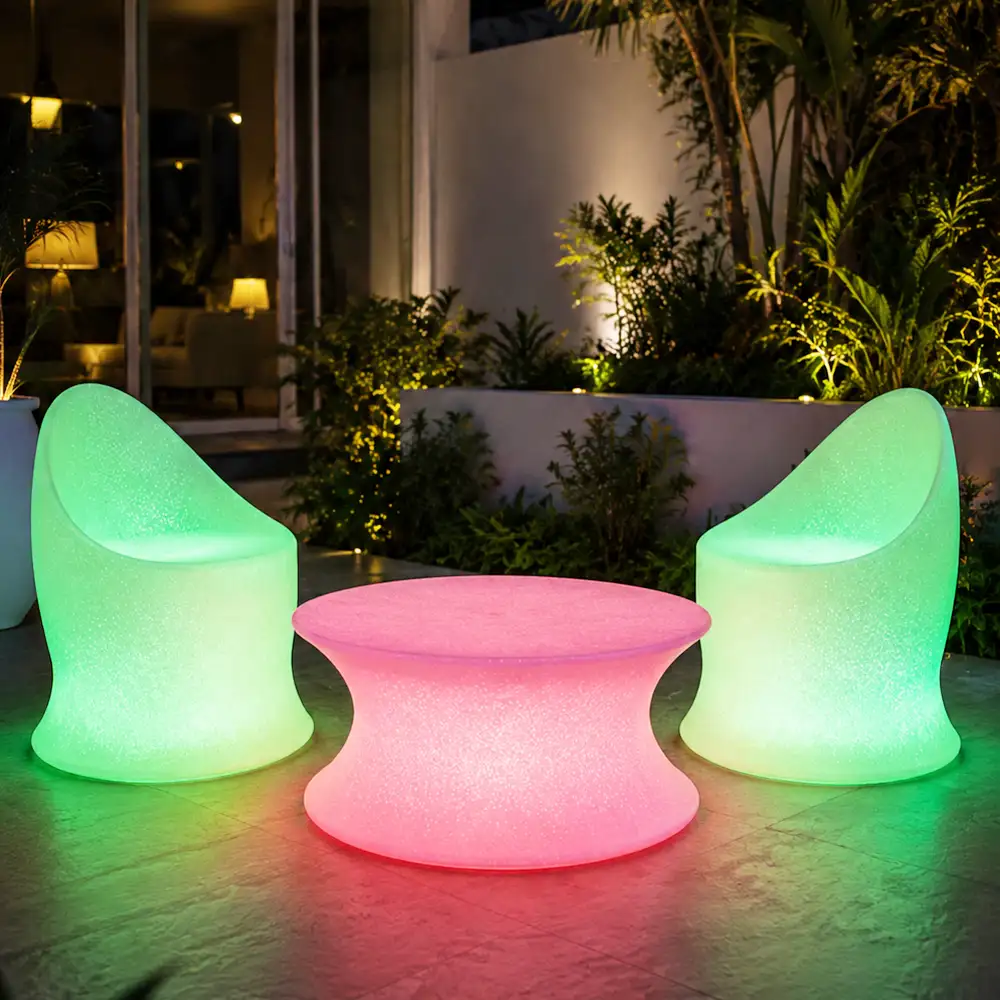 Marvella and Olivia Illuminated Set — LED outdoor chair and coffee table in White Stone glowing at night