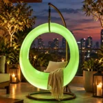 Milo Illuminated Garden Swing — LED outdoor swing in White Stone glowing in a garden at night