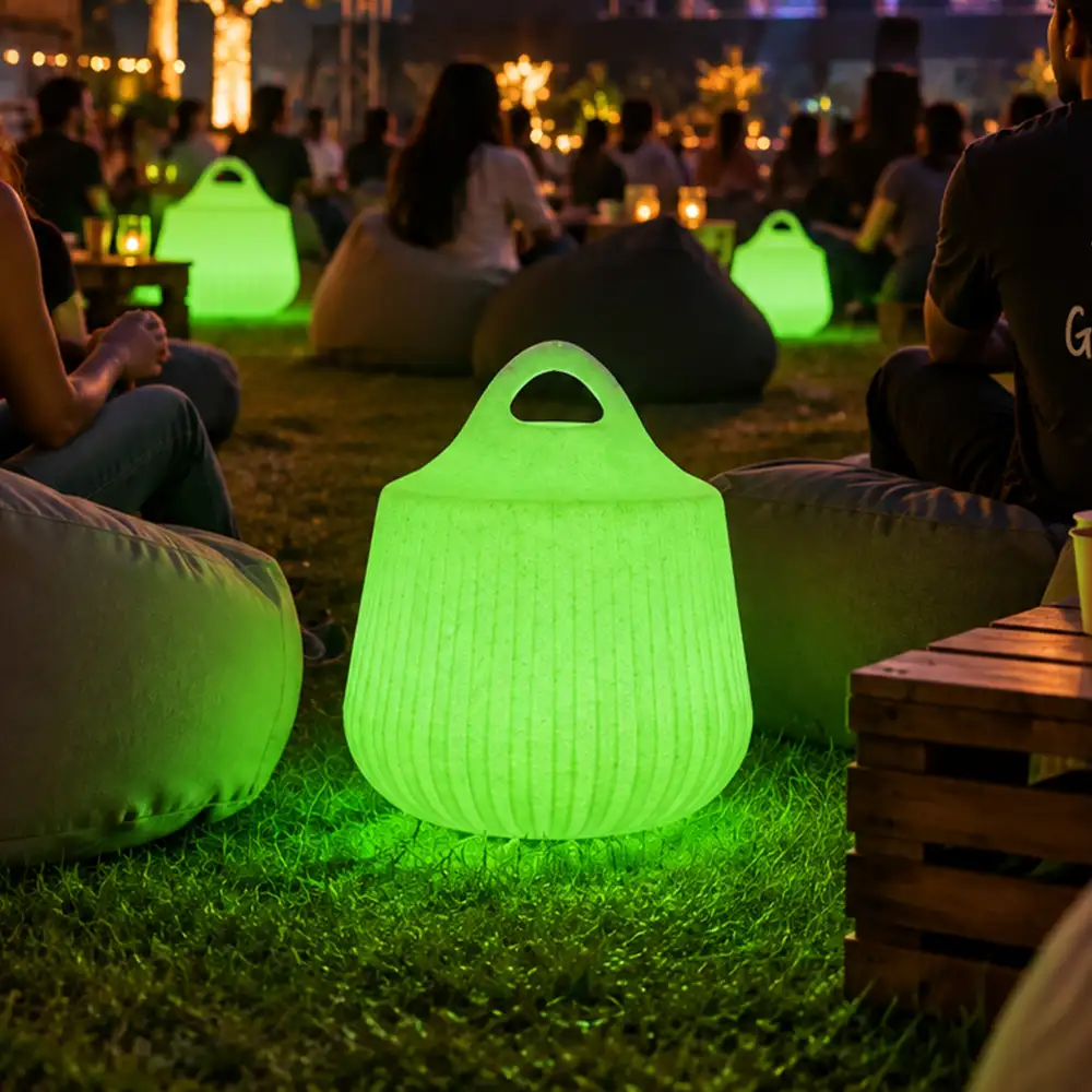 Rio Illuminated Pouffe — LED outdoor stool in White Stone glowing after dark