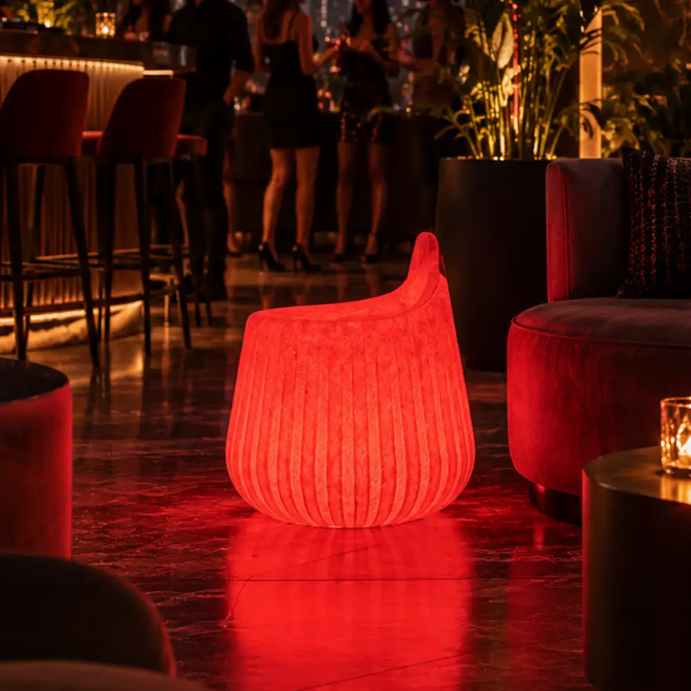 Rio Illuminated Pouffe — LED outdoor stool in White Stone glowing after dark