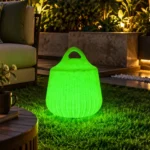 Rio Illuminated Pouffe — LED outdoor stool in White Stone glowing after dark