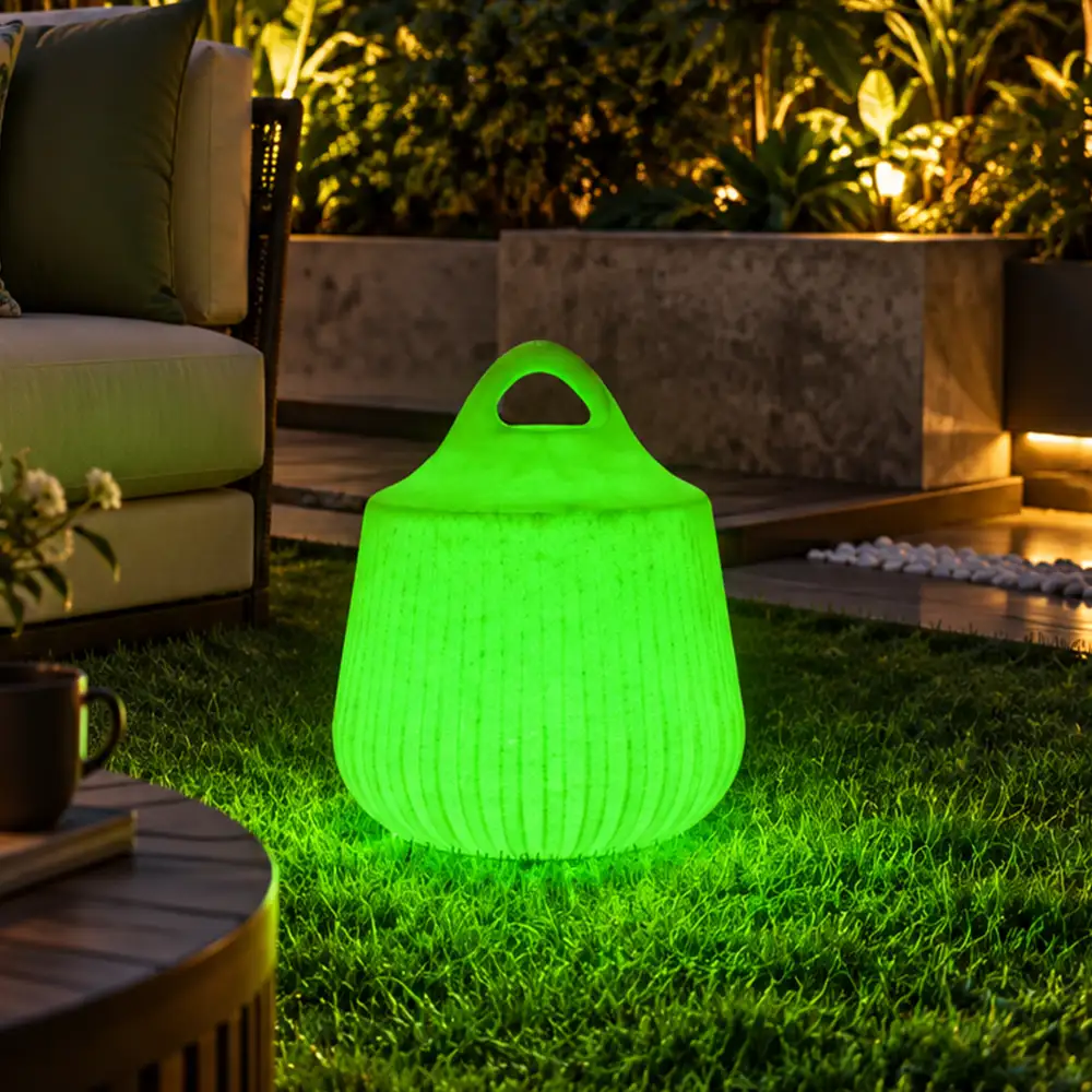 Rio Illuminated Pouffe — LED outdoor stool in White Stone glowing after dark