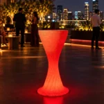Sirocco Illuminated Bar Table, LED bar table in White Stone glowing on a rooftop terrace